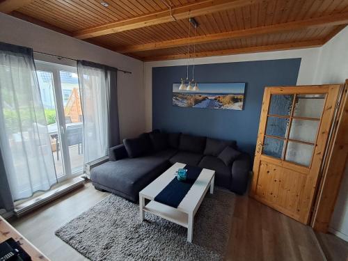 a living room with a couch and a table at Fewo Backboard in Graal