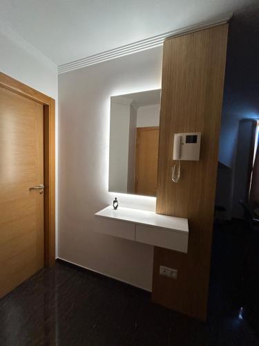 a bathroom with a white sink and a mirror at Vista Santa Mariña in Cambados