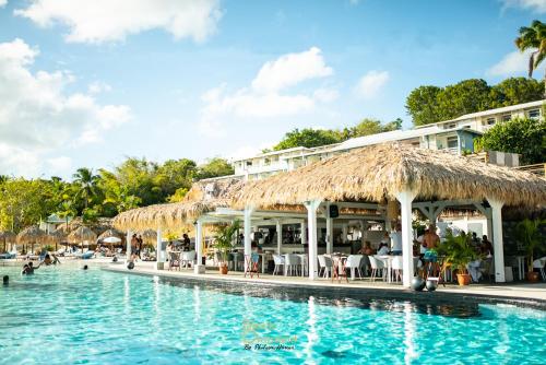 una piscina con un hotel e un resort di Diamant Bleu studio, piscine, vue mer a Le Diamant