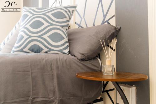 a bed with a table and a pillow on it at ZM Rooted Properties in Frankfort