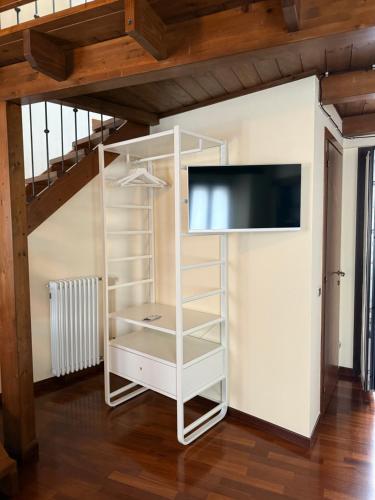 a white book shelf with a flat screen tv at Casa Teresina in Mercatale