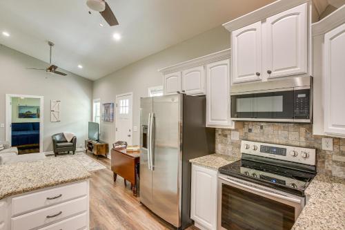a kitchen with white cabinets and stainless steel appliances at half Mi to Kentucky Downs Franklin Home with Patio! in Franklin