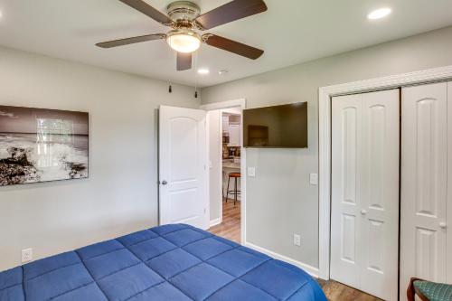 a bedroom with a blue bed and a ceiling fan at half Mi to Kentucky Downs Franklin Home with Patio! in Franklin