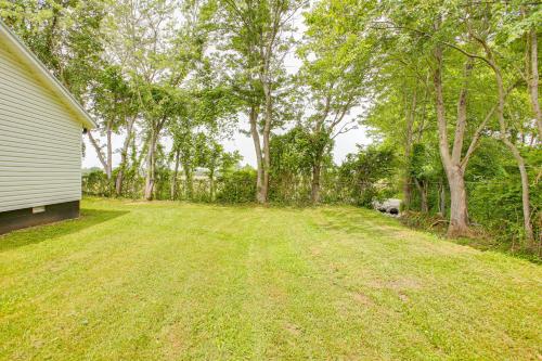 an empty yard next to a house with trees at half Mi to Kentucky Downs Franklin Home with Patio! in Franklin