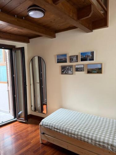 a bedroom with a bed and a mirror on the wall at Casa Teresina in Mercatale