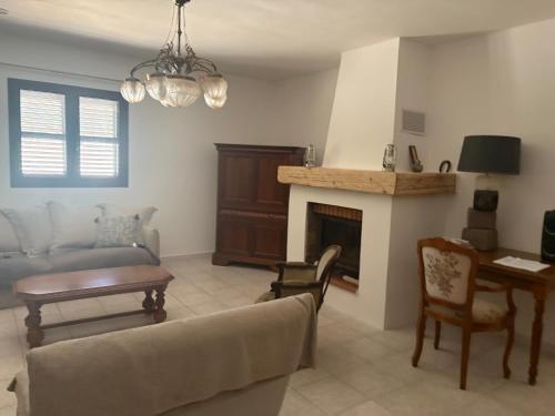 a living room with a couch and a fireplace at Entre mer et maquis- maison avec piscine privée - 8 minutes plage tizzano in Sartène