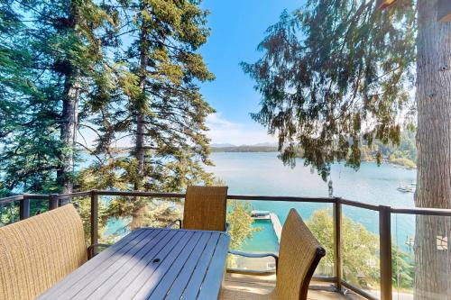 a table and chairs on a balcony with a view of a lake at DeJa View in Hayden