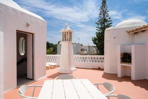 a white lighthouse on the roof of a house at Clifftop Vila Verde - 4BR, Beachside, Pool, AC in Porches