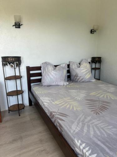a bed with white pillows and aedes at Апартаменты в 5 минутах от моря, пляж Черноморка, Одесса in Odesa