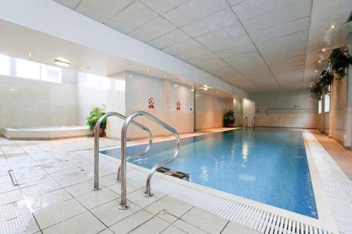 a large swimming pool in a building with a pooliterator at Royal Station Hotel- Part of the Cairn Collection in Newcastle upon Tyne