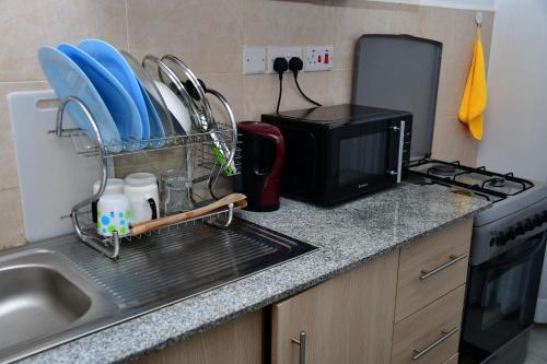 Η κουζίνα ή μικρή κουζίνα στο Haven Cozy Apartments