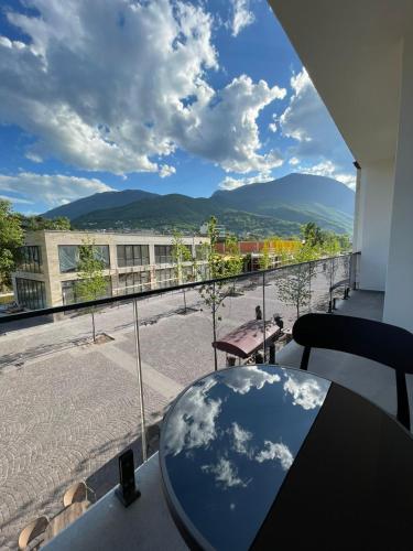 a balcony with a table and a view of the mountains at Jon Apartments in Peje