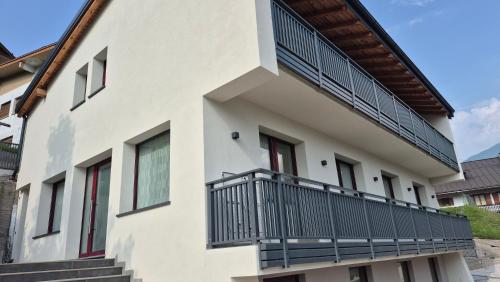 a building with balconies on the side of it at Alps lodge in Domegge di Cadore