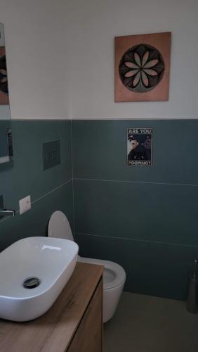 a bathroom with a white sink and a toilet at Domus in Horto in Perdifumo