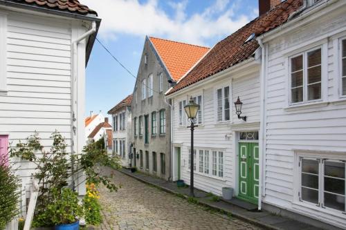 a street with white houses and a street light at Apartment in old Stavanger in Stavanger