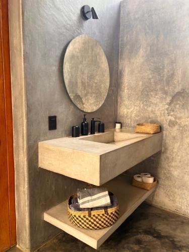 a bathroom with a sink and a mirror at Casa Copal Troncones - Bungalows con Alberca Privada in Troncones