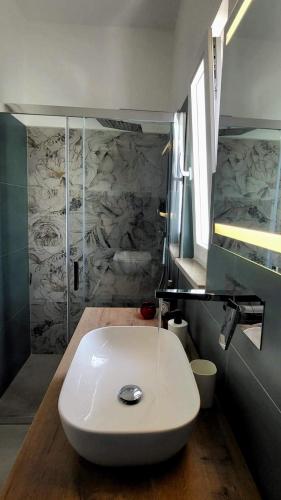 a white toilet in a bathroom with a shower at Domus in Horto in Perdifumo