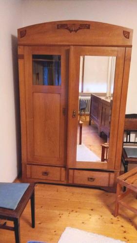 a wooden cabinet with a mirror in a room at Ferienwohnung Melba in Traben-Trarbach
