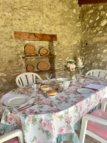 a table with a floral table cloth and plates on it at Casa Angela in Toscolano Maderno