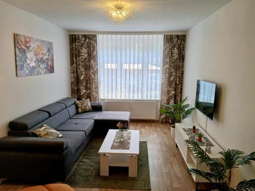 a living room with a couch and a table at Ferienwohnung König in Arendsee