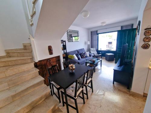 a living room with a table and a couch at Casa Triana in Costa Teguise