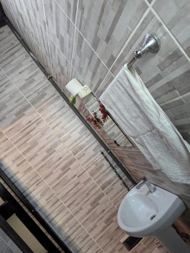 a bathroom with a toilet and a sink at Rams Eng Home in Douala