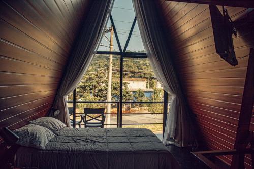 a bed in a room with a large window at Tena Tower House TTH in Tena