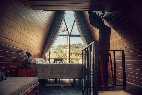 a room with a bed and a large window at Tena Tower House TTH in Tena