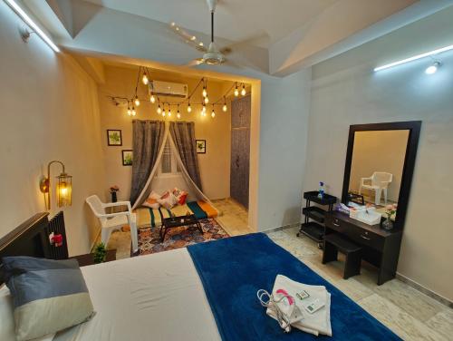 a bedroom with a bed and a desk and a mirror at Hidden Gem - Fully Furnished 1BHK with Café Lights & Canopy, AC & Fast Wifi in Hyderabad
