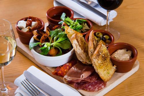 a plate of food on a table with a salad at Mercure Newbury West Grange Hotel in Thatcham
