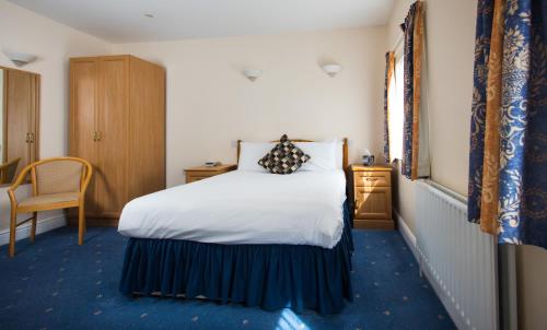 a hotel room with a bed and a window at Mercure Newbury West Grange Hotel in Thatcham