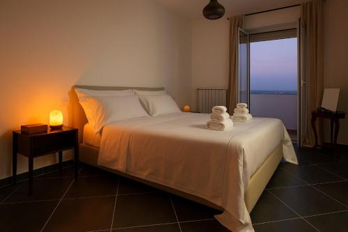 a bedroom with a bed with towels on it at Gate 10 in Bari