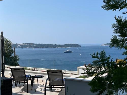 a patio with chairs and a view of the water at Apartment Infinity Blue in Mlini