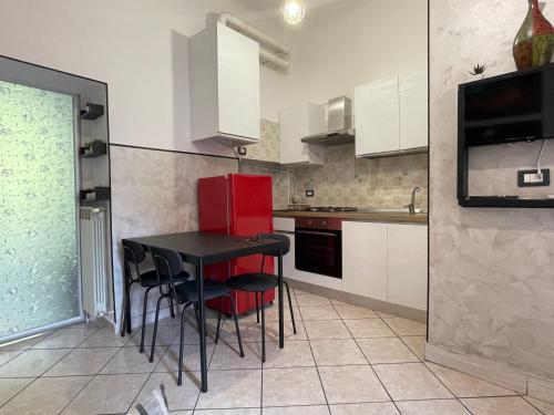 a kitchen with a black table and black chairs at Rho Fiera - H Galeazzi - Welcome Home in Pero in Pero