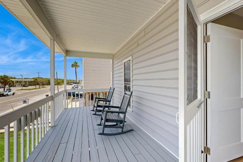 a porch with rocking chairs on a house at A Shore Thing in Edisto Beach