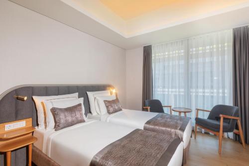 Postel nebo postele na pokoji v ubytování Meroddi Beyoğlu Residence