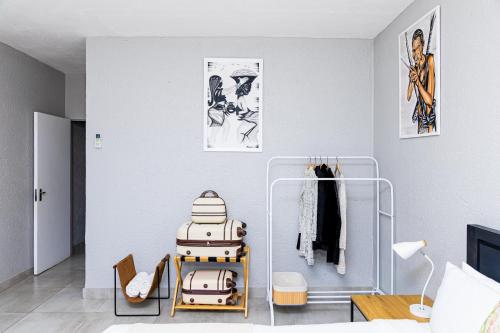 a room with white walls and a room with a suitcase at Mills Pad with 2-bedroom in Nelspruit