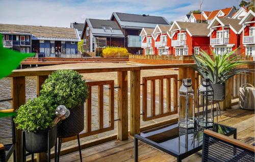 a balcony with a wooden deck with houses at 3 Bedroom Stunning Home In Holmsbu in Holmsbu