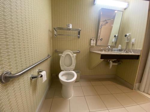 a bathroom with a toilet and a sink at Wingate by Wyndham Fort Saskatchewan in Fort Saskatchewan