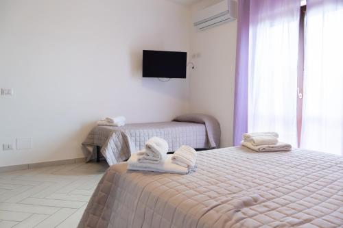 Postel nebo postele na pokoji v ubytování Agriturismo L'Oasi