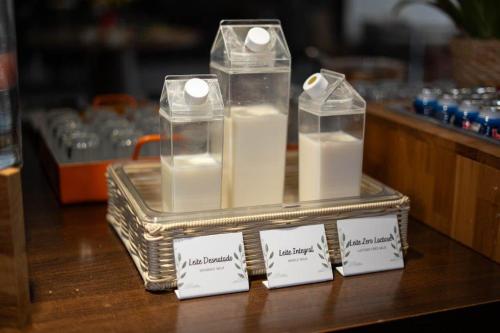 a display of candles in plastic containers on a table at Hotel Heritage in Sao Paulo