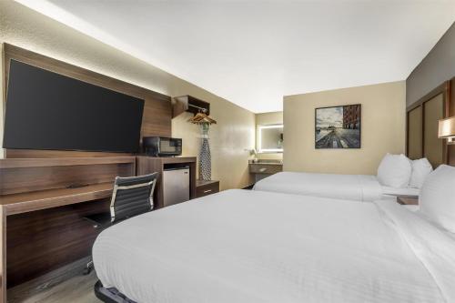 a hotel room with two beds and a flat screen tv at Best Western Salisbury Plaza in Salisbury