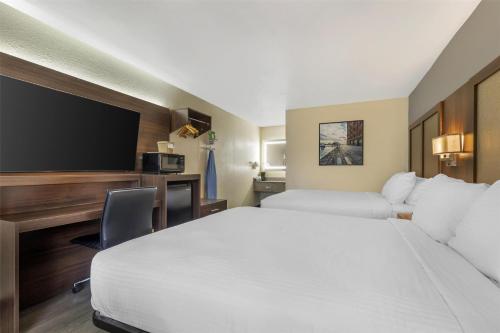 a hotel room with two beds and a tv at Best Western Salisbury Plaza in Salisbury
