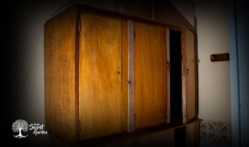 a wooden cabinet in the corner of a room at Secret Garden in Cusco