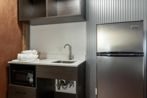 a kitchen with a sink and a refrigerator at Studio 6 Limon, CO I 70 in Limon