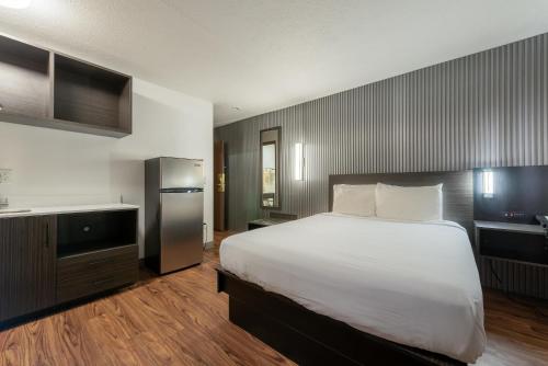 a bedroom with a large bed and a television at Studio 6 Limon, CO I 70 in Limon