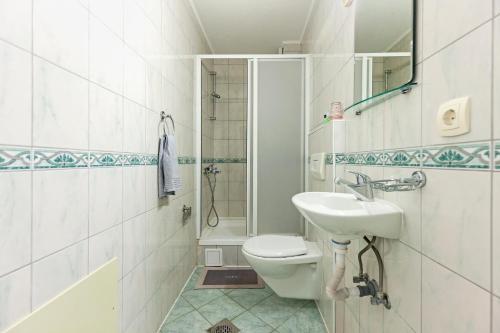 a bathroom with a toilet and a sink and a shower at Villa Miranda NG in Ohrid