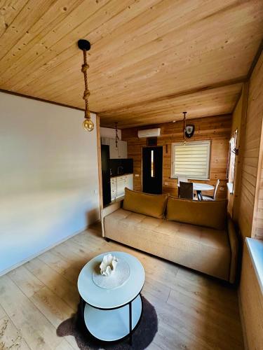 a living room with a couch and a table at Žvejo Namelis prie Jūros in Melnragė