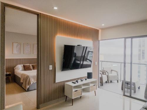a bedroom with a bed and a large mirror at Bocagrande Infinitum Vista mar Gym Coworking in Cartagena de Indias