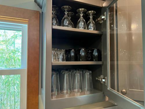 a cabinet filled with glass jars and vases at 3BR Home - Near The Landing - Free Tickets Included - Cottonwood Cottage in Branson